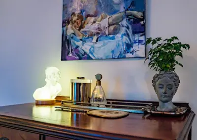 a table with a statue and a vase on it at Twin Gables of Woodstock in Woodstock