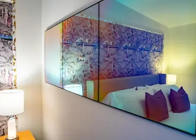 a bedroom with a large mirror above a bed at Twin Gables of Woodstock in Woodstock