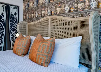 a bedroom with a white bed with pillows and a wall at Twin Gables of Woodstock in Woodstock