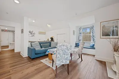 a living room with a blue couch and chairs at Brook Farm Inn in Lenox