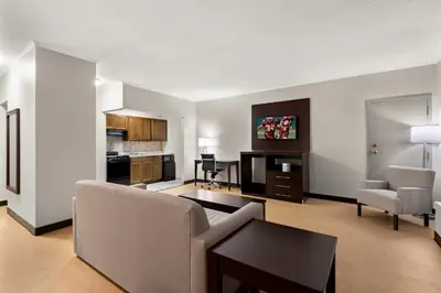 a living room with a couch and a table at Red Roof Inn Norwich in Norwich