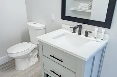 a white bathroom with a toilet and a sink at Pocono Mountain Villas MOD Collection by Sonesta in East Stroudsburg