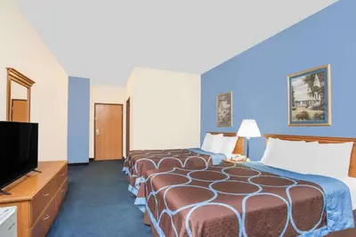 a hotel room with two beds and a flat screen tv at Super 8 by Wyndham Cobleskill NY in Cobleskill