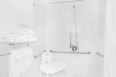 a white bathroom with a toilet and a shower at Super 8 by Wyndham Cobleskill NY in Cobleskill