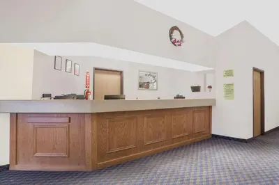 a large room with a reception desk in a hospital at Super 8 by Wyndham Cobleskill NY in Cobleskill
