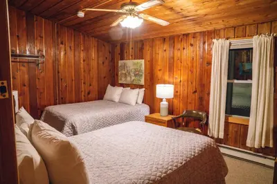 a bedroom with two beds and a ceiling fan at Gray Ghost Inn in West Dover
