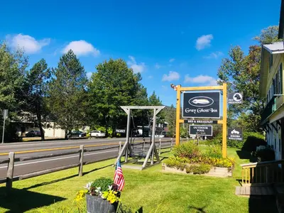 a sign for a cafe on the side of a road at Gray Ghost Inn in West Dover
