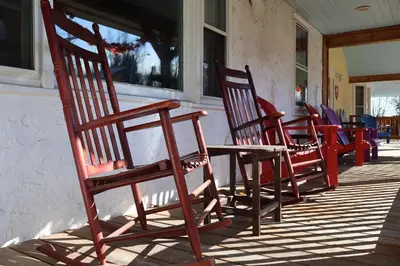 a row of rocking chairs sitting on a porch at Gray Ghost Inn in West Dover