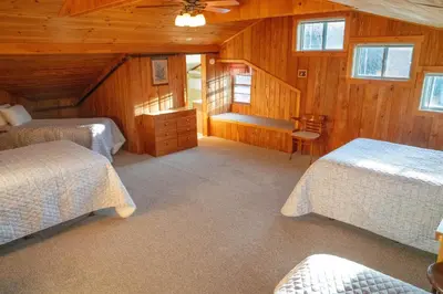a bedroom with two beds and a ceiling fan at Gray Ghost Inn in West Dover