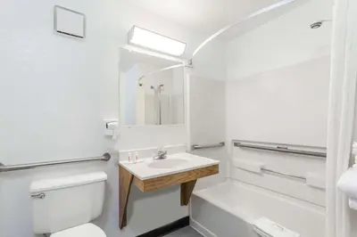a white bathroom with a sink and a toilet at Super 8 by Wyndham Norwich in Norwich