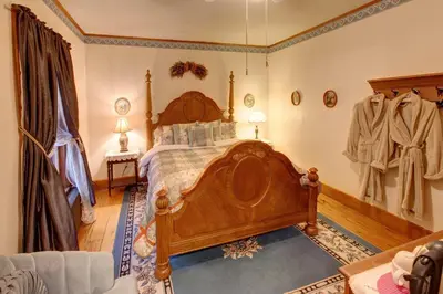 a bedroom with a wooden bed in a room at Margaretville Mountain Inn B&B in Margaretville