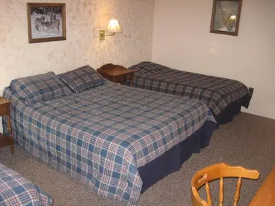 a hotel room with two beds and a table at Big Bears Lodge in West Dover