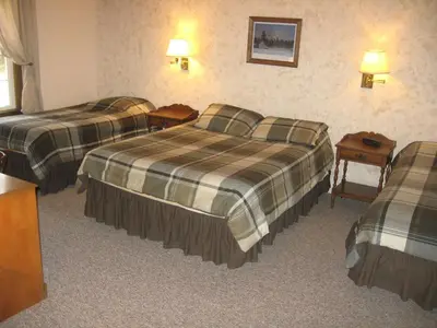 a hotel room with two beds and a table at Big Bears Lodge in West Dover