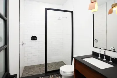 a bathroom with a shower and a toilet and a sink at Woodstock Way Hotel in Woodstock