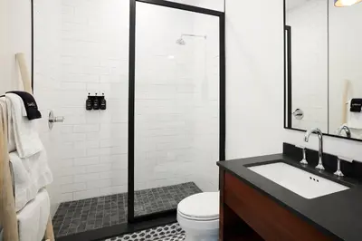 a bathroom with a shower and a toilet and a sink at Woodstock Way Hotel in Woodstock
