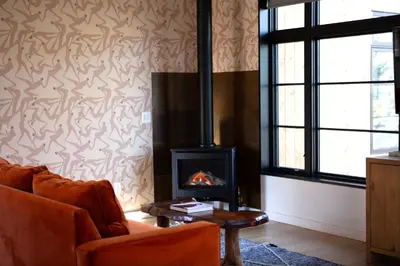 a living room with a couch and a fireplace at Woodstock Way Hotel in Woodstock