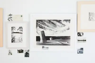 a group of framed photographs on a wall at Tourists in North Adams