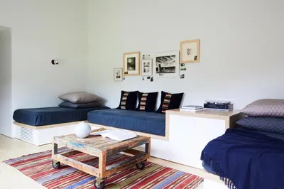 a living room with two beds and a coffee table at Tourists in North Adams