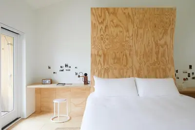 a bedroom with a white bed and a wooden wall at Tourists in North Adams