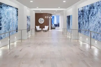 a hallway with blue and white paintings on the walls at Residence Inn by Marriott Stamford Downtown in Stamford