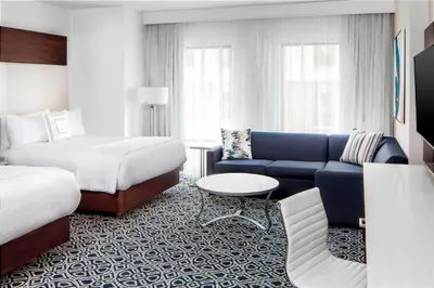 a hotel room with a couch and a bed at Residence Inn by Marriott Stamford Downtown in Stamford