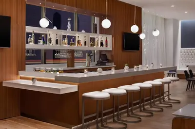 a bar in a restaurant with stools at Residence Inn by Marriott Stamford Downtown in Stamford