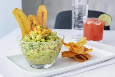 a bowl of guacamole on a plate with chips at Residence Inn by Marriott Stamford Downtown in Stamford