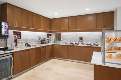 a kitchen with wooden cabinets and a counter with donuts at Residence Inn by Marriott Stamford Downtown in Stamford