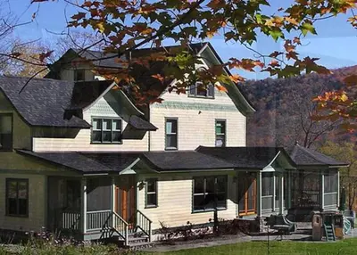 a large white house with a black roof at Breezy Hill Inn in Fleischmanns