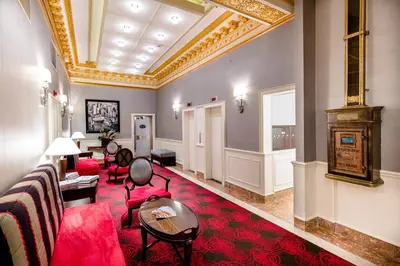a living room with red furniture and a ceiling at Radio City Apartments in New York