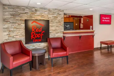 a red rock tavern with two chairs and a counter at Red Roof Inn Queensbury in Queensbury