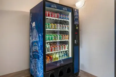a vending machine filled with lots of sodas and drinks at Red Roof Inn Queensbury in Queensbury