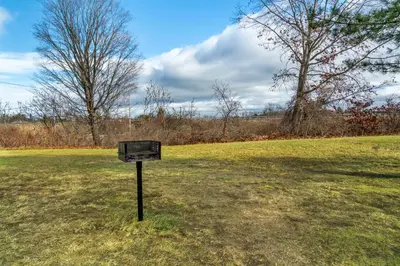 a sign in the grass in a field at Red Roof Inn Queensbury in Queensbury