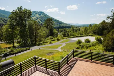 a balcony with a view of a river and mountains at Scribner's Catskill Lodge, a Member of Design Hotels in Hunter