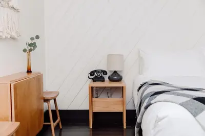 a bedroom with a bed and a table with a lamp at Scribner's Catskill Lodge, a Member of Design Hotels in Hunter