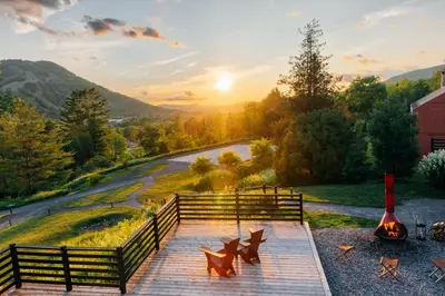 a wooden pathway with a sunset in the background at Scribner's Catskill Lodge, a Member of Design Hotels in Hunter