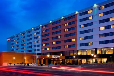 a large building with a street in front of it at Sheraton Hartford Hotel at Bradley Airport in Windsor Locks