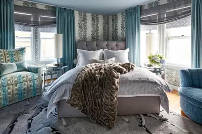 a bedroom with a bed and a chair and windows at The Cornell Inn, Lenox & The Berkshires in Lenox