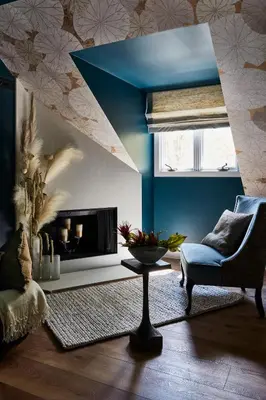 a living room with a fireplace and a blue wall at The Cornell Inn, Lenox & The Berkshires in Lenox