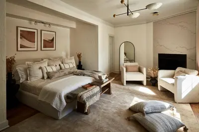 a bedroom with a large bed and a living room at The Cornell Inn, Lenox & The Berkshires in Lenox