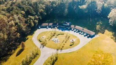 an aerial view of a house in the middle of a lake at The Little Lion in Great Barrington