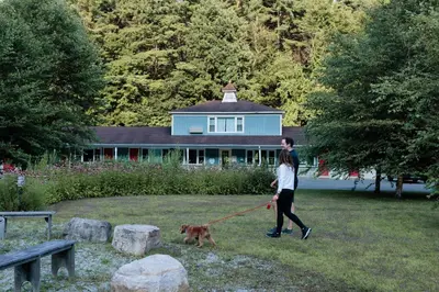 a woman walking a dog on a leash at The Little Lion in Great Barrington
