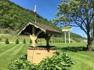 a statue of a house in the middle of a field at Scottish Inns Milford in Milford