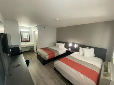 a hotel room with two beds and a television at Motel 6-Windsor Locks, CT - Hartford in Windsor Locks