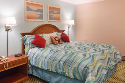 a bedroom with a bed with pillows on it at Rodeway Inn Milford - I-84 in Milford
