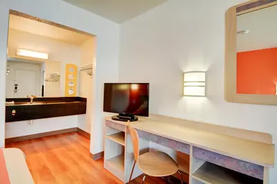 a room with a desk with a flat screen tv at Motel 6-Southington, CT - Hartford in Southington