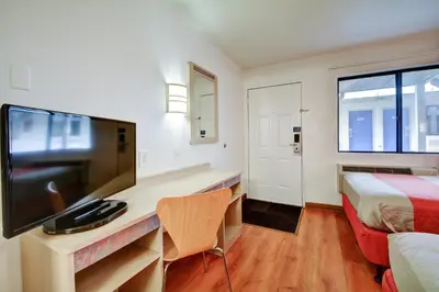a hotel room with a desk with a tv and a bed at Motel 6-Southington, CT - Hartford in Southington