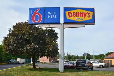 a sign for a dentys office in a parking lot at Motel 6-Southington, CT - Hartford in Southington