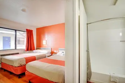 a hotel room with two beds and a shower at Motel 6-Southington, CT - Hartford in Southington