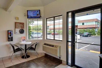 a waiting room with a table and a window at Motel 6-Wethersfield, CT - Hartford in Wethersfield